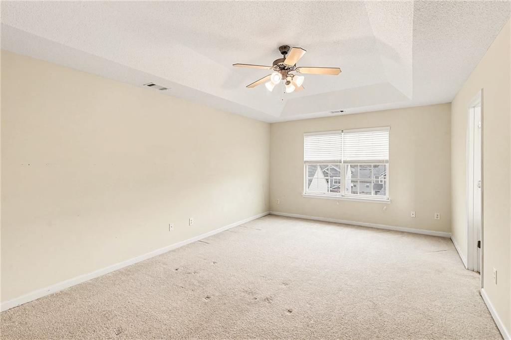 7676 Rutgers Circle Fairburn, GA 30213 - Photo 20 of 33 an empty room with windows and fan