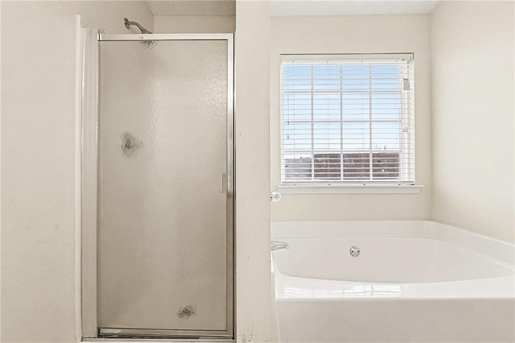 7676 Rutgers Circle Fairburn, GA 30213 - Photo 25 of 33 a bathroom with a shower and a bathtub