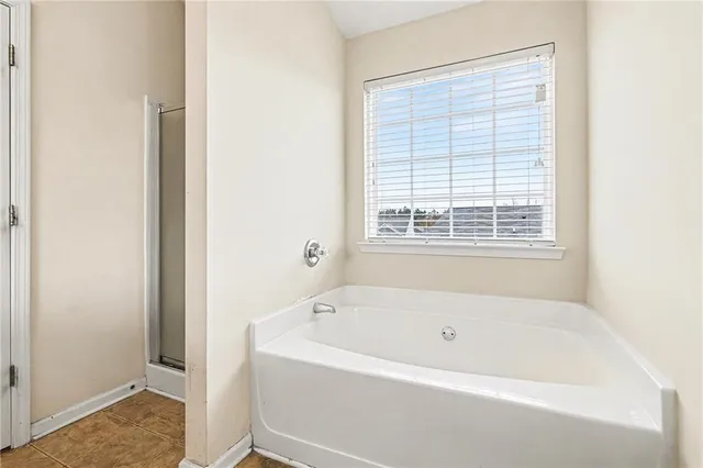 a white bath tub sitting next to a window