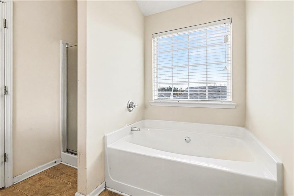 7676 Rutgers Circle Fairburn, GA 30213 - Photo 26 of 33 a white bath tub sitting next to a window