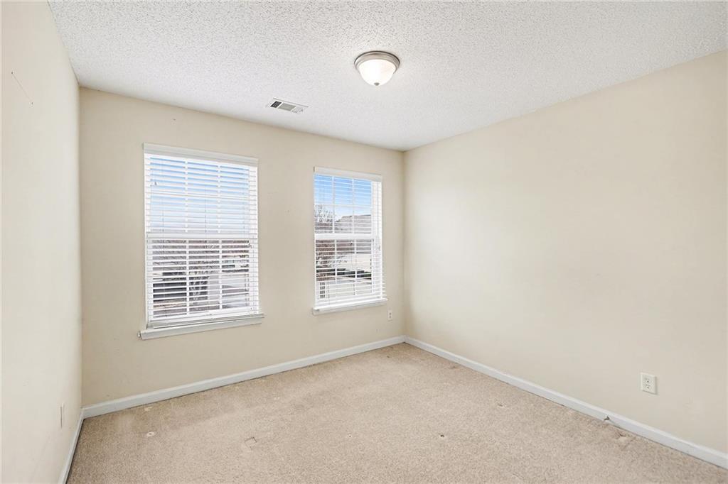 7676 Rutgers Circle Fairburn, GA 30213 - Photo 30 of 33 a view of an empty room with a window