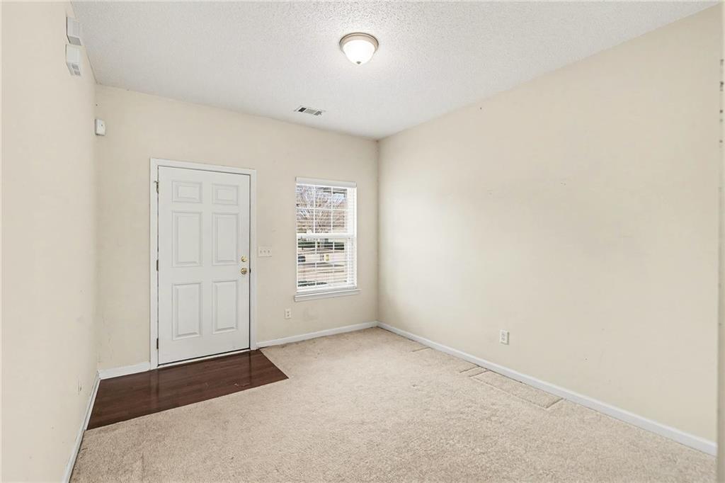 7676 Rutgers Circle Fairburn, GA 30213 - Photo 4 of 33 an empty room with windows
