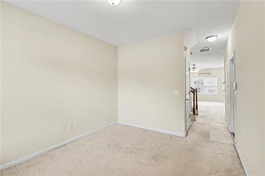 7676 Rutgers Circle Fairburn, GA 30213 - Photo 5 of 33 a view of a hallway with wooden shelves