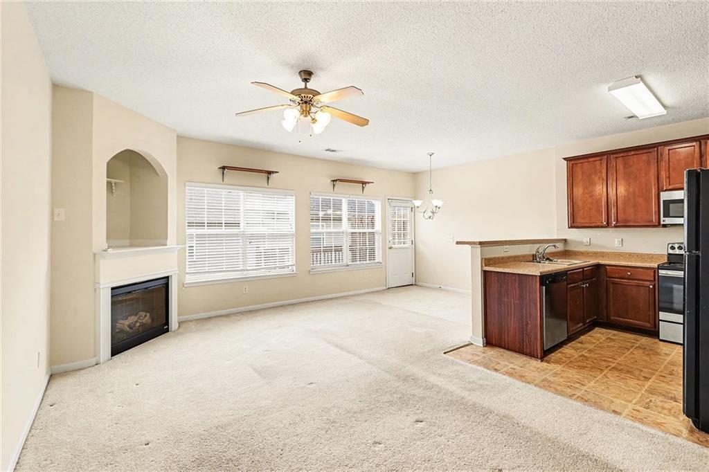 7676 Rutgers Circle Fairburn, GA 30213 - Photo 8 of 33 a kitchen with a stove a sink and a refrigerator
