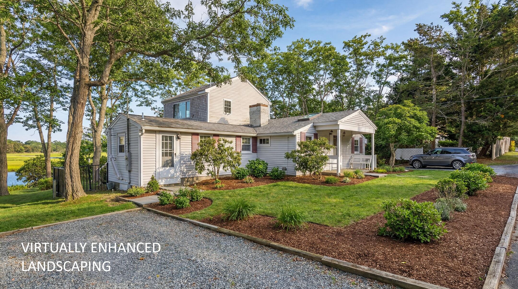 181 Rock Harbor Road Orleans, MA 02653 - Photo 1 of 16 a front view of a house with a garden