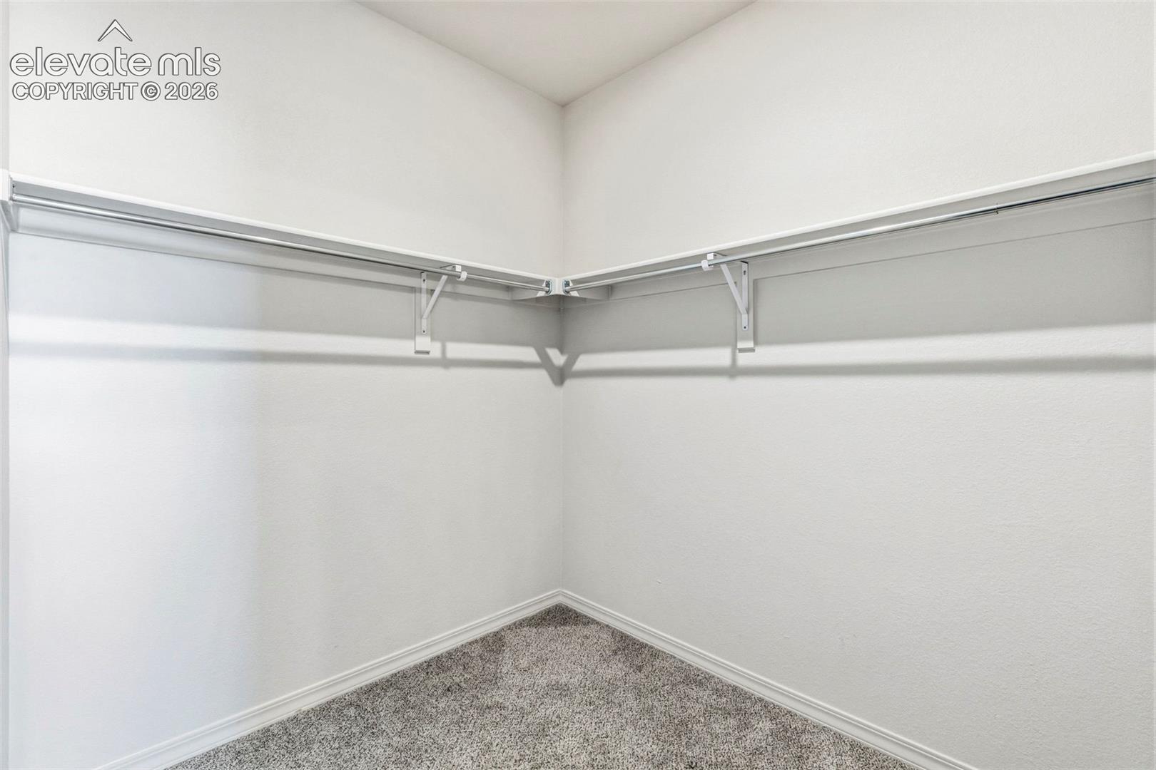 3955 North Yoder Road Yoder, CO 80864 - Photo 25 of 38 Corner closet featuring white shelving and chrome hanging rods