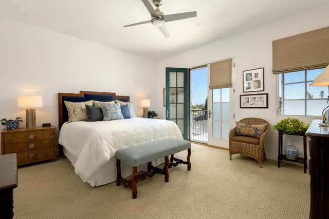 a spacious bedroom with a bed and a couch