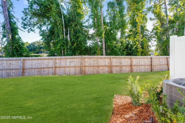 a view of a backyard with tree