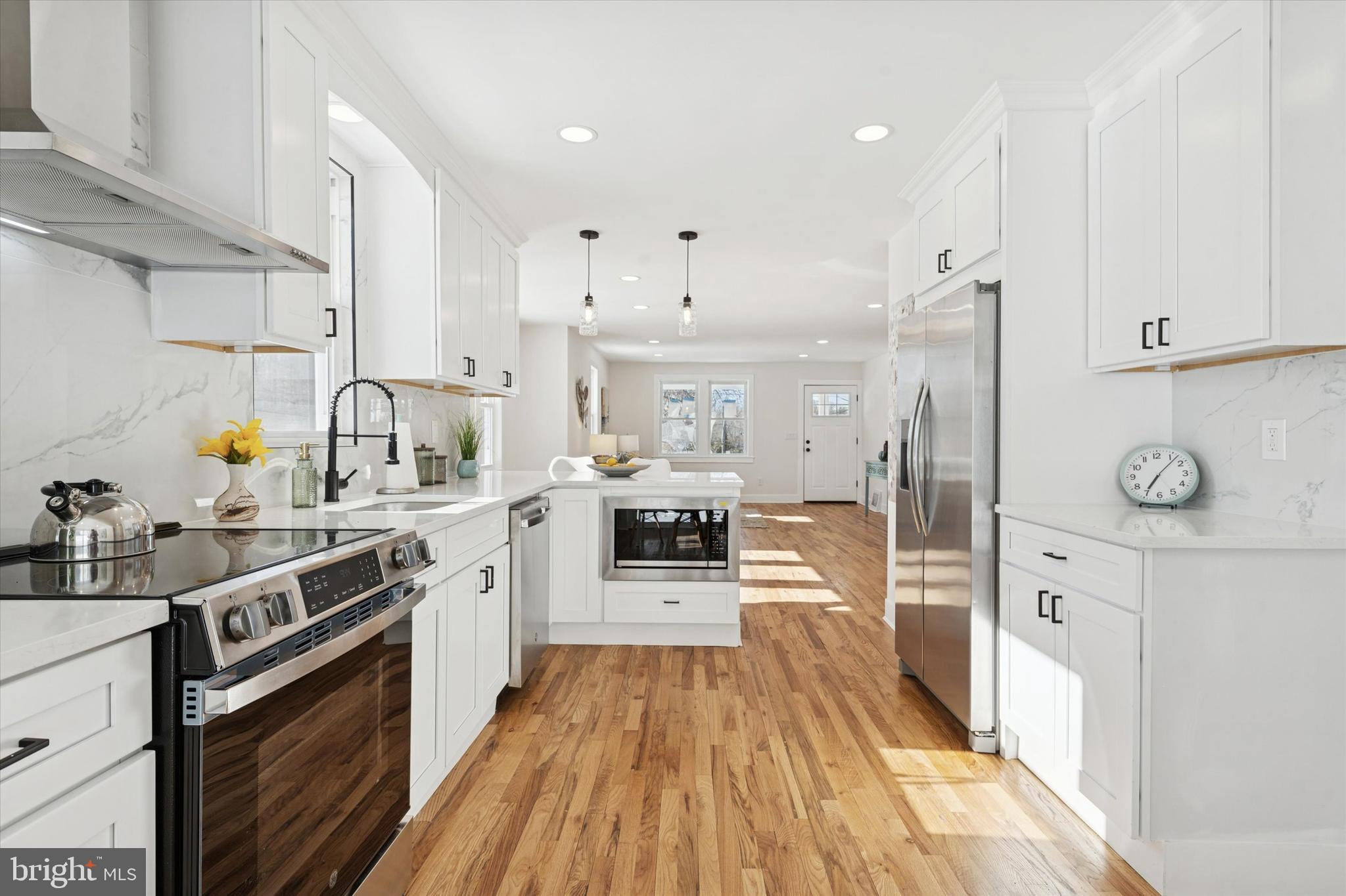 624 Convent Road Aston, PA 19014 - Photo 11 of 26 a large kitchen with stainless steel appliances granite countertop a lot of counter space and wooden floors