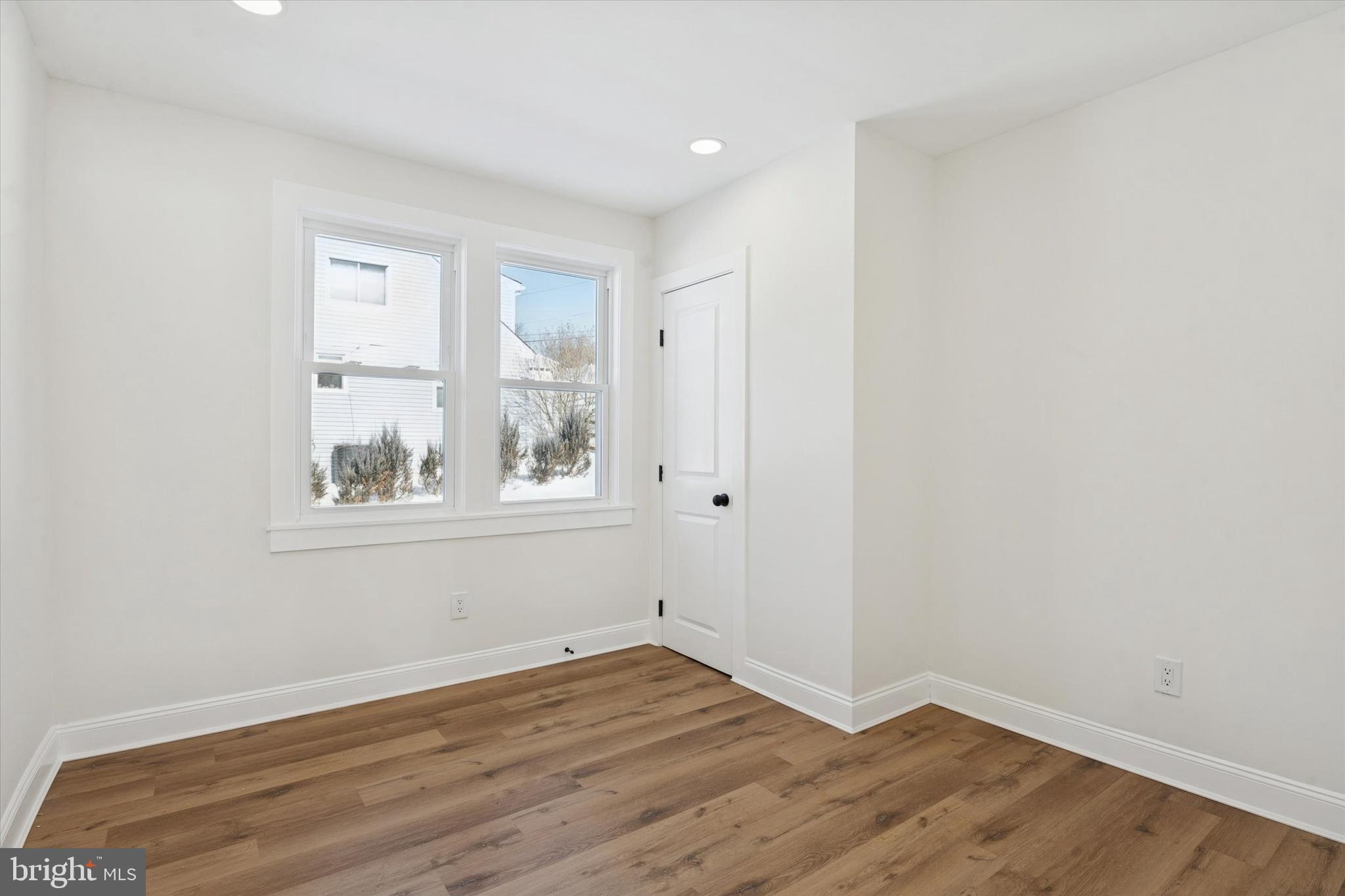 624 Convent Road Aston, PA 19014 - Photo 15 of 26 a view of an empty room with wooden floor and a window