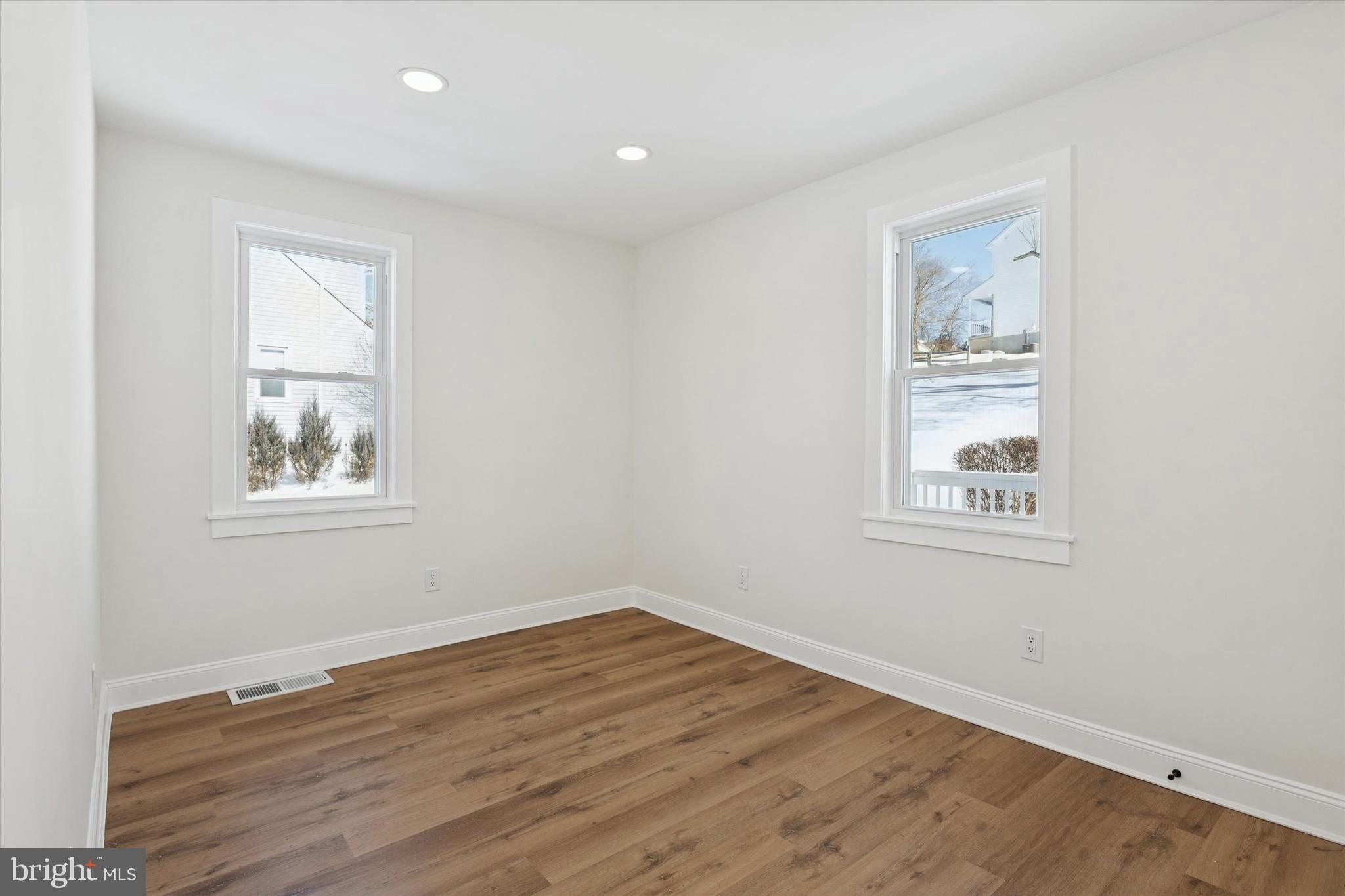 624 Convent Road Aston, PA 19014 - Photo 17 of 26 a view of an empty room with wooden floor and a window