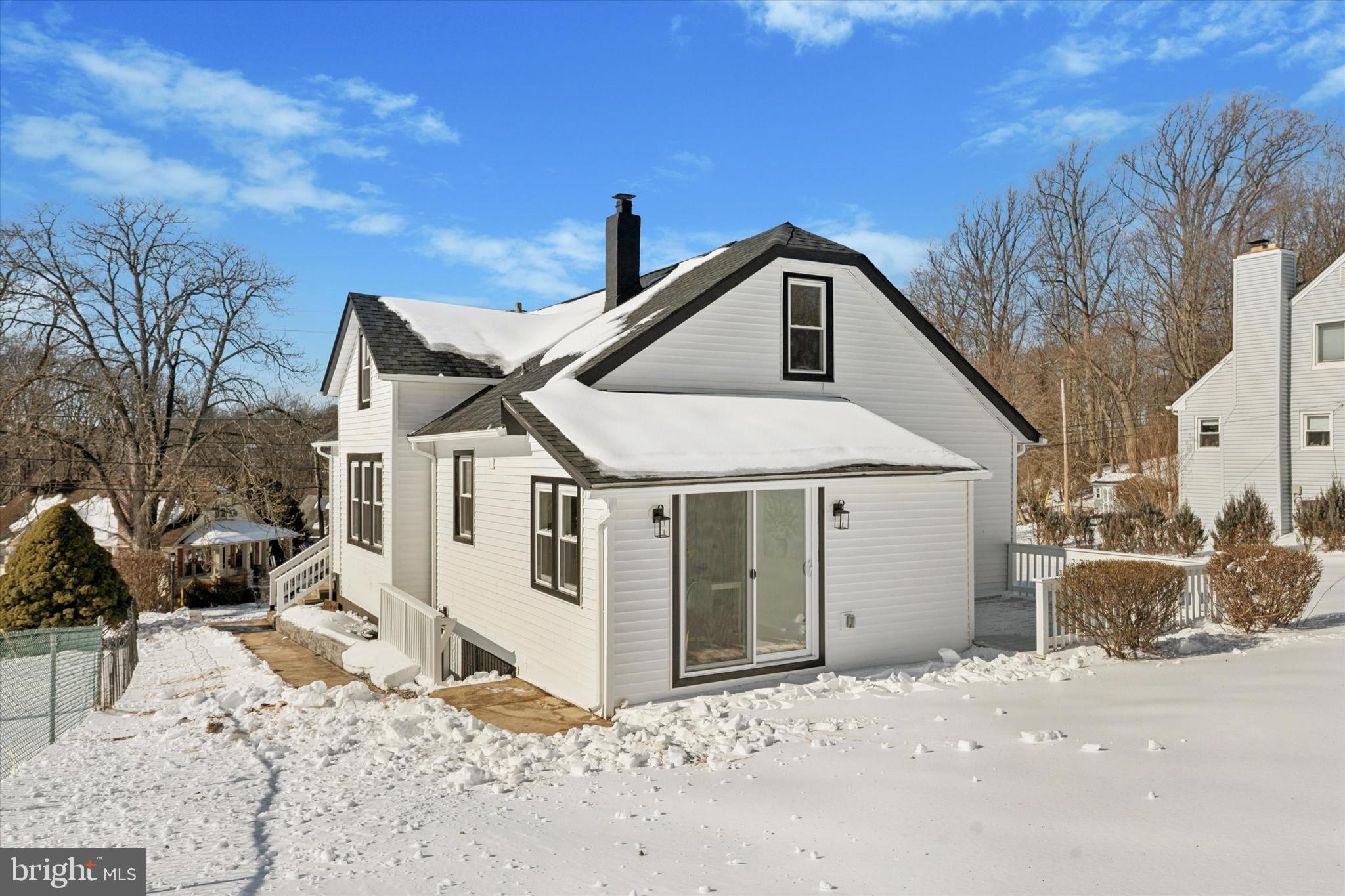 624 Convent Road Aston, PA 19014 - Photo 25 of 26 a front view of a house with a yard covered in snow