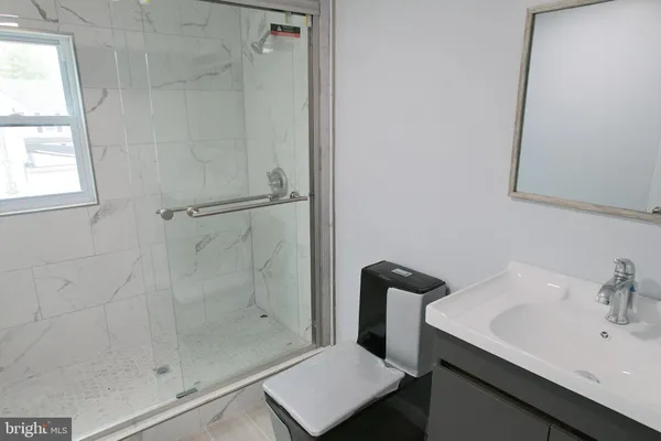a bathroom with a sink and a shower