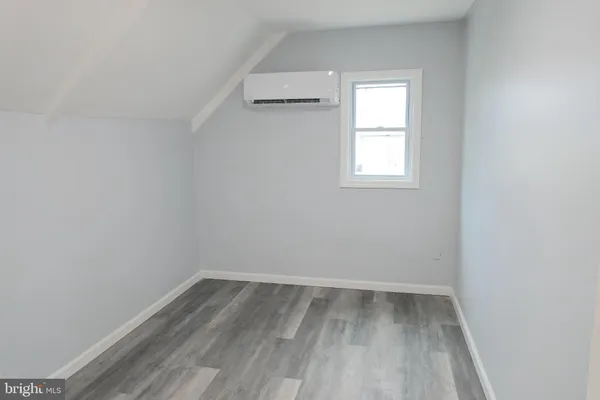 a view of a room with wooden floor and window