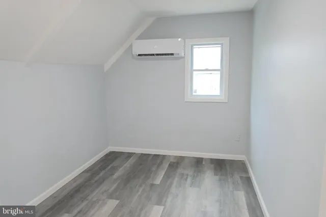 a view of a room with wooden floor and window