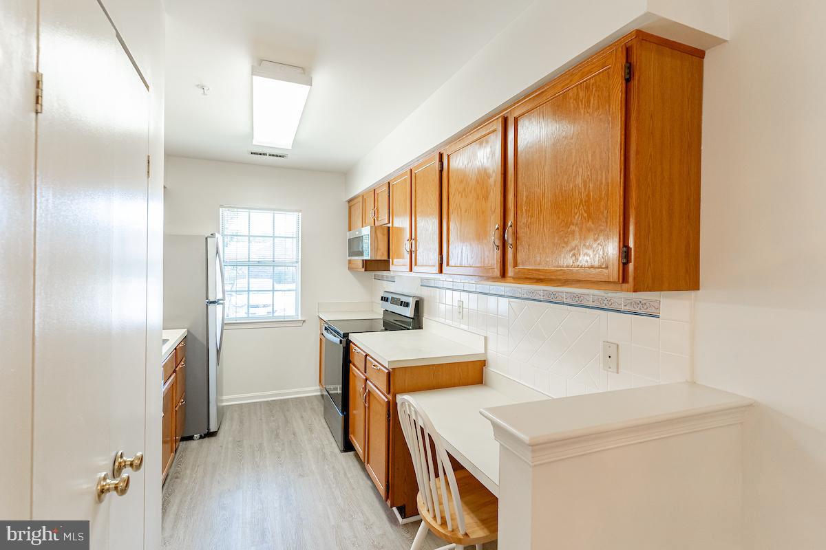 9268 Cherry Lane, Unit 57 Laurel, MD 20708 - Photo 7 of 33 Kitchen with all new SS appliances and flooring