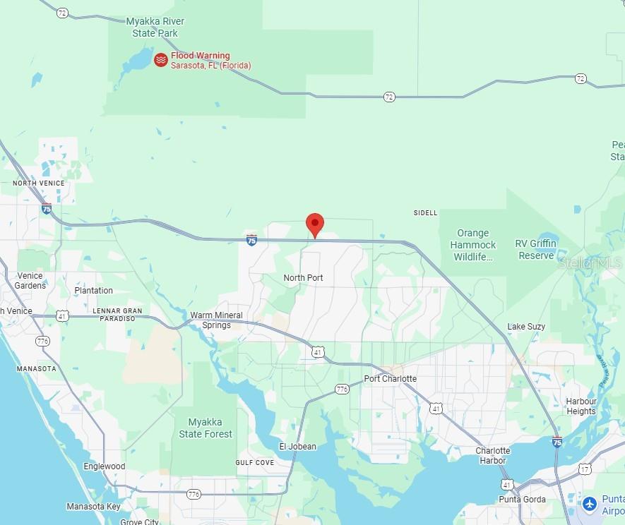 28 Lagrange Avenue North Port, FL 34286 - Photo 5 of 6 a picture of a living room with a white comforter and a wooden floor