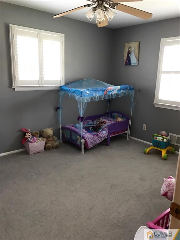 33 Andover Road Jackson, NJ 08527 - Photo 12 of 25 a bedroom with a bed and a chandelier