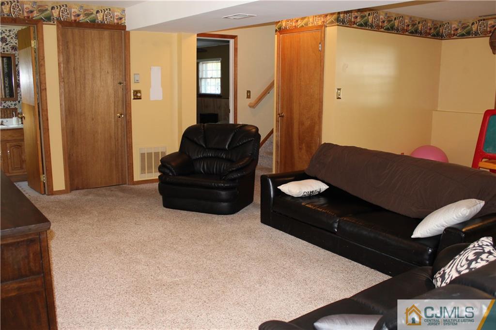 33 Andover Road Jackson, NJ 08527 - Photo 14 of 25 a living room with furniture and a air conditioner vent