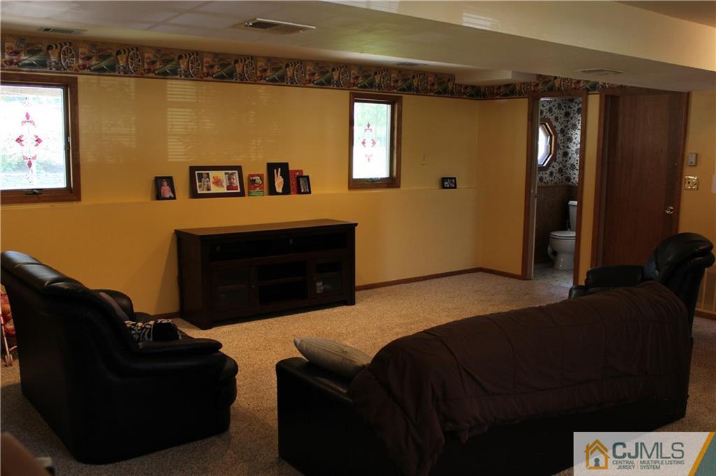 33 Andover Road Jackson, NJ 08527 - Photo 15 of 25 a living room with furniture and a fireplace