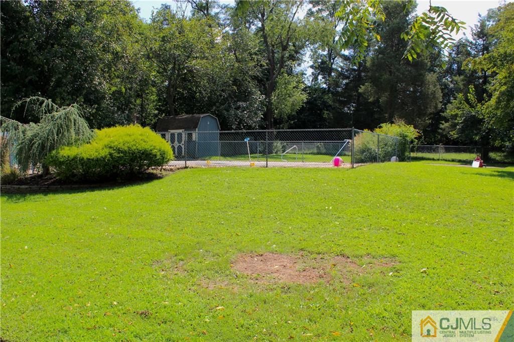 33 Andover Road Jackson, NJ 08527 - Photo 21 of 25 a view of yard with swimming pool and green space