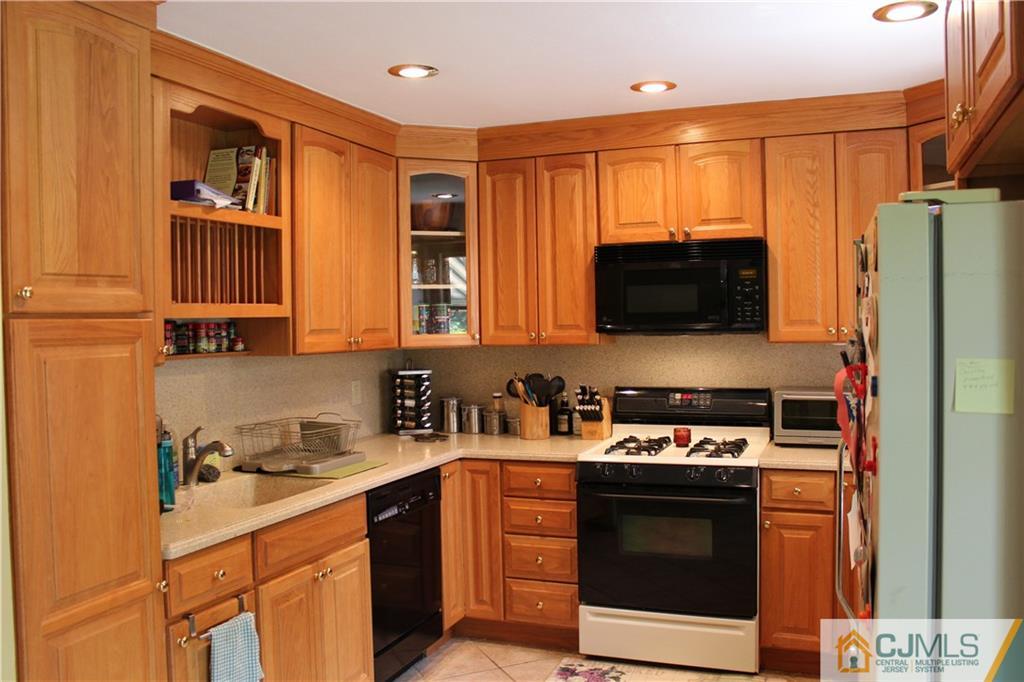 33 Andover Road Jackson, NJ 08527 - Photo 8 of 25 a kitchen with stainless steel appliances a stove microwave and refrigerator