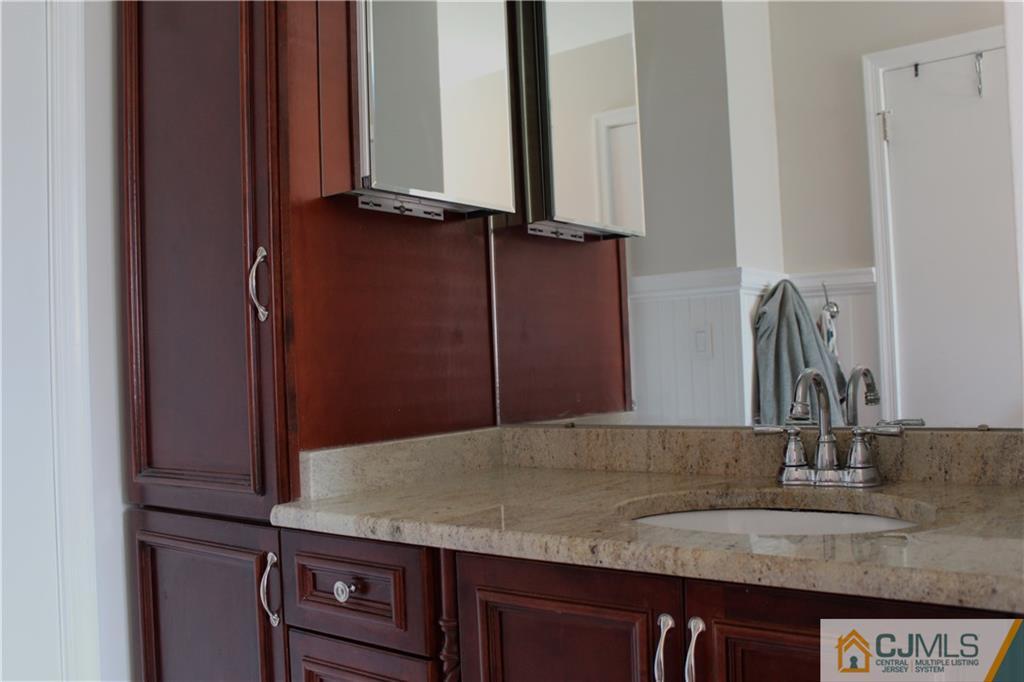 33 Andover Road Jackson, NJ 08527 - Photo 10 of 25 a bathroom with a granite countertop sink and a mirror