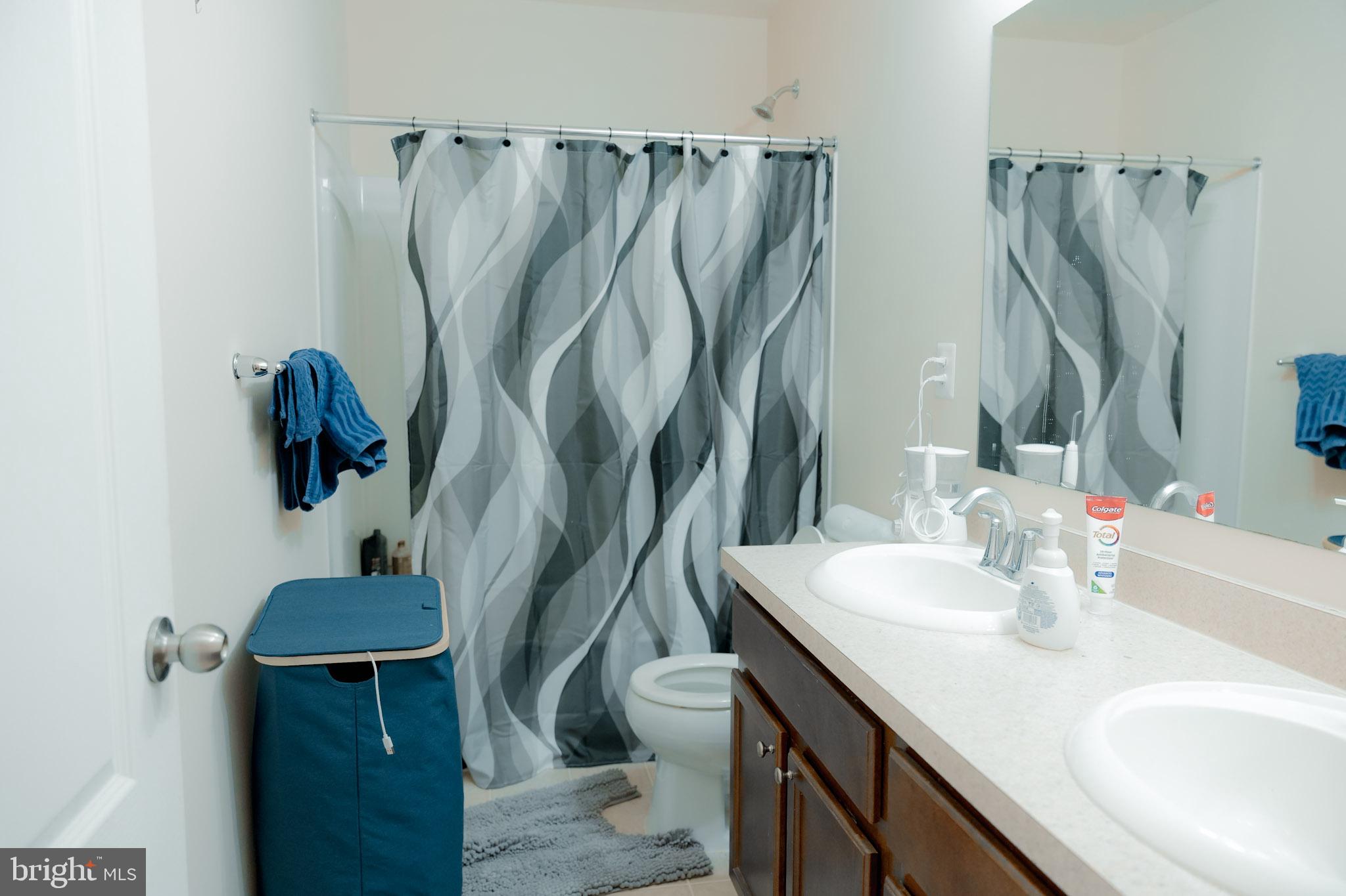 8453 Winding Trail Laurel, MD 20724 - Photo 12 of 24 a bathroom with a sink and a mirror