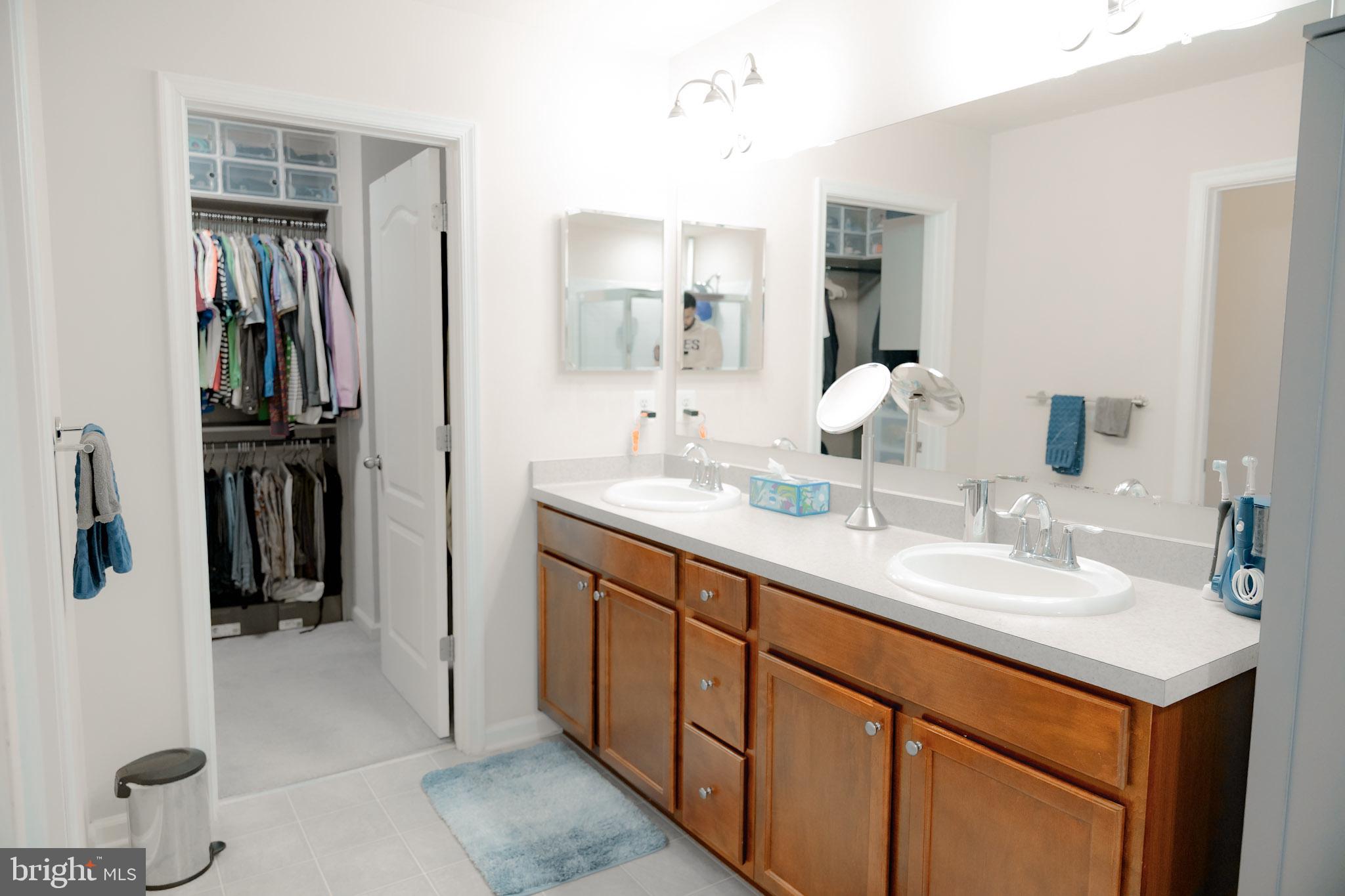 8453 Winding Trail Laurel, MD 20724 - Photo 14 of 24 a bathroom with a double vanity sink and mirror