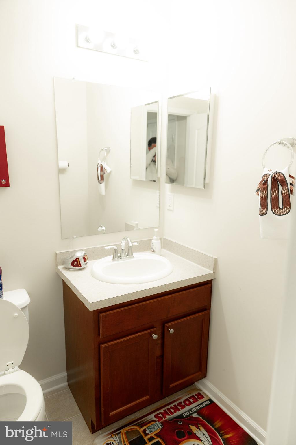 8453 Winding Trail Laurel, MD 20724 - Photo 16 of 24 a bathroom with a sink a toilet and mirror