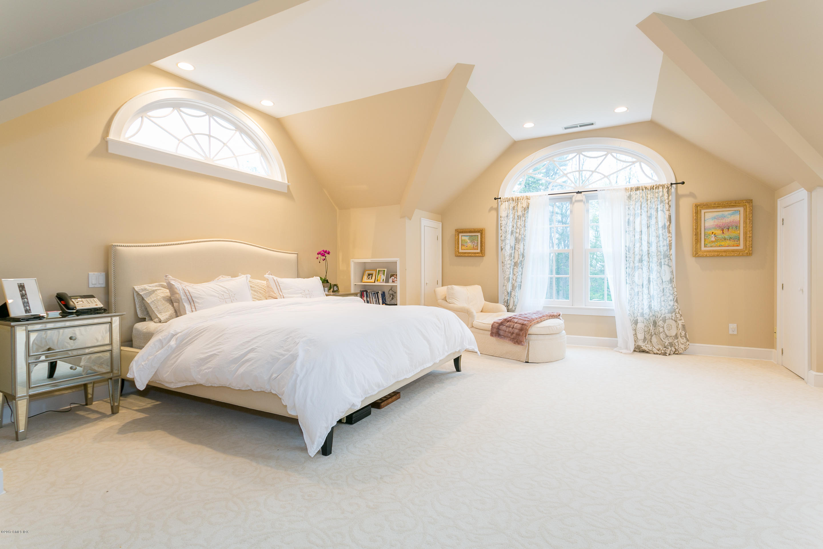 20 Dewart Road Greenwich, CT 06830 - Photo 15 of 22 a spacious bedroom with a bed a mirror and a large window
