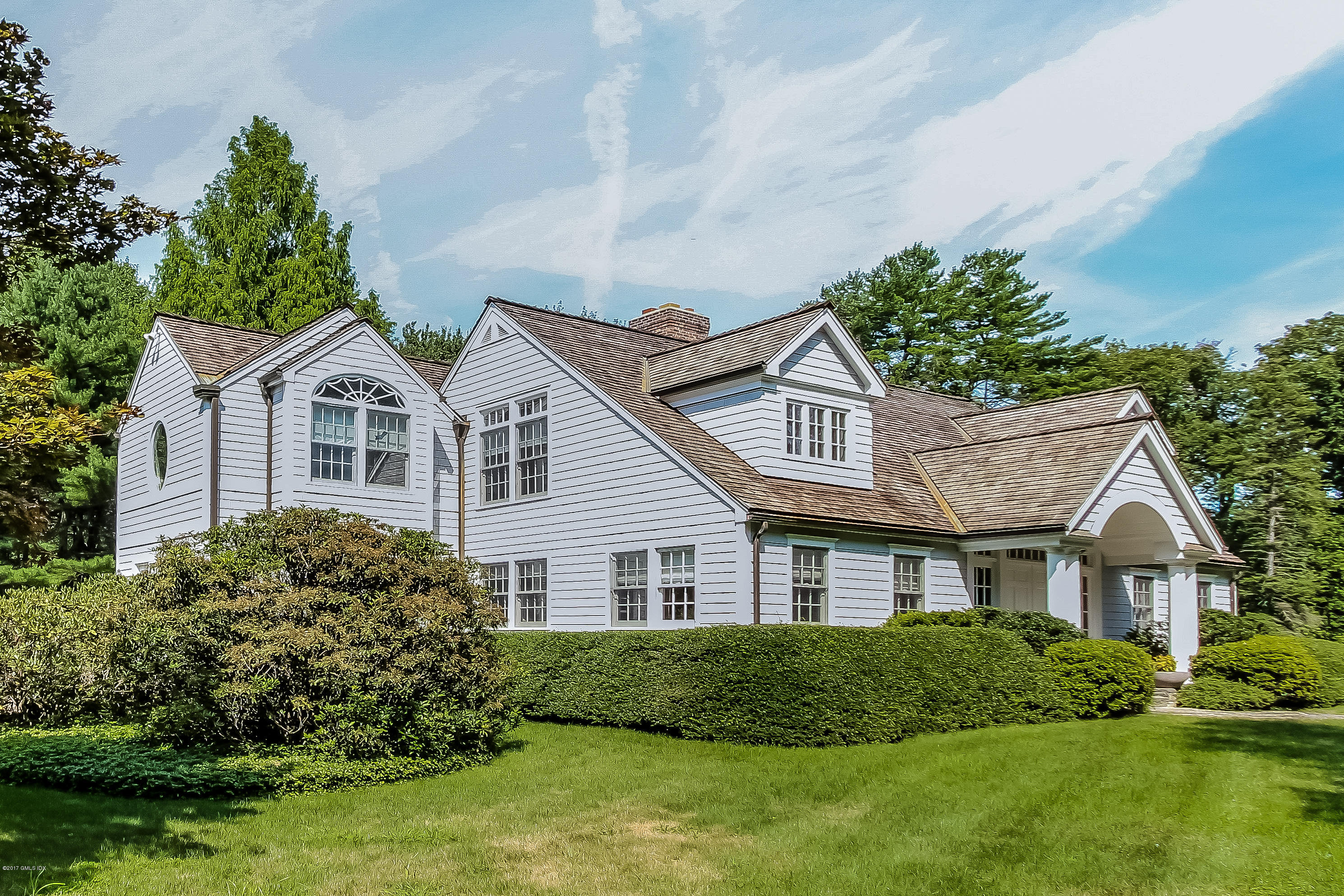 20 Dewart Road Greenwich, CT 06830 - Photo 3 of 22 a front view of a house with a yard and potted plants
