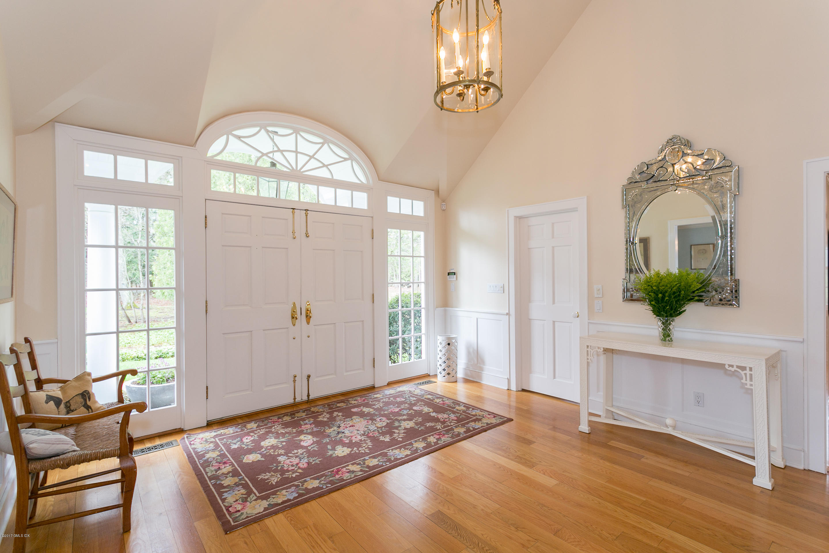 20 Dewart Road Greenwich, CT 06830 - Photo 4 of 22 a view of a livingroom with wooden floor and a chandelier