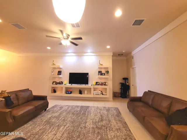a living room with furniture and view of kitchen