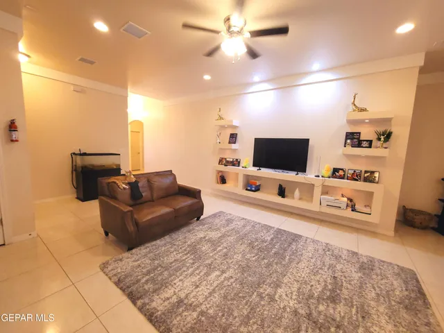 a kitchen with stainless steel appliances kitchen island granite countertop a refrigerator a stove a sink a dining table and chairs with wooden floor