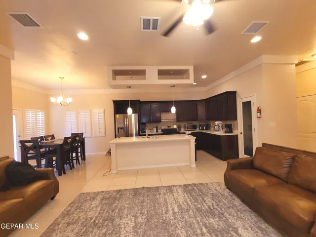 a kitchen with stainless steel appliances a sink a refrigerator a counter top space and cabinets