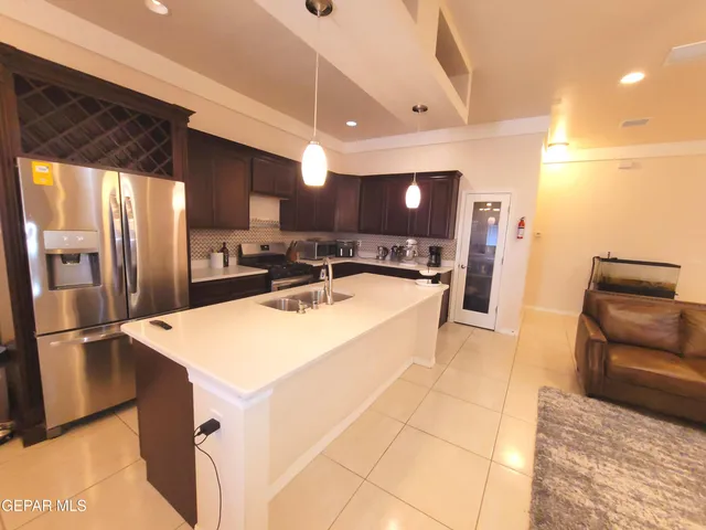 a view of a dining room with furniture and a chandelier