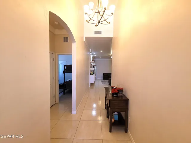 a view of a hallway with wooden floor and a bathroom