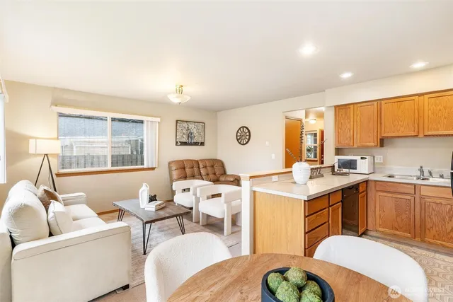 a living room with furniture a fireplace and a large window
