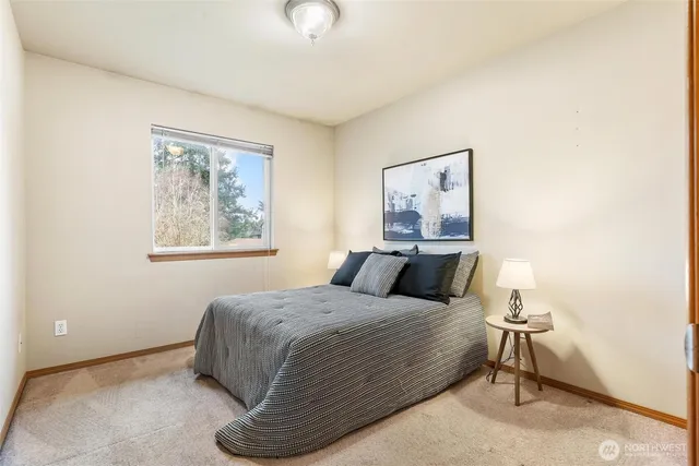 a view of a hallway with bathroom and wooden floor
