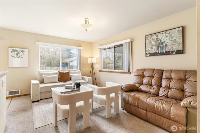 a living room with furniture a table and a window