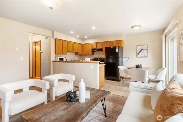 a living room with furniture and kitchen view