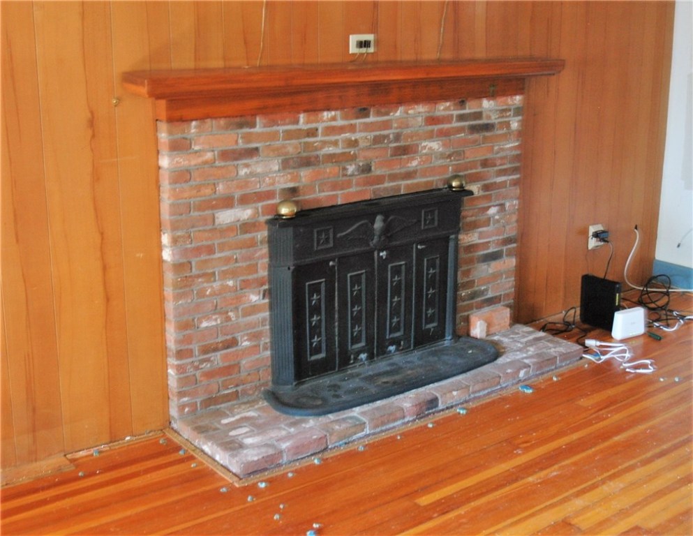 401 New Meadow Road Barrington, RI 02806 - Photo 10 of 11 Brick fireplace and hearth in living room