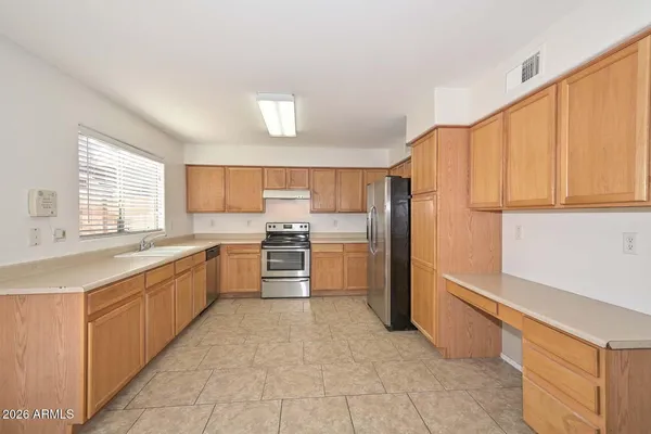 a kitchen with stainless steel appliances a refrigerator and a stove