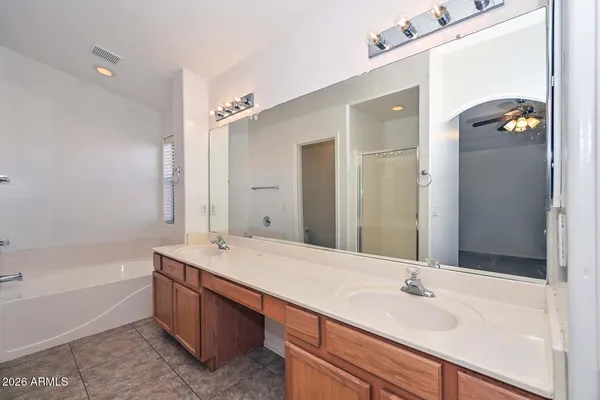a bathroom with a tub sink and mirror