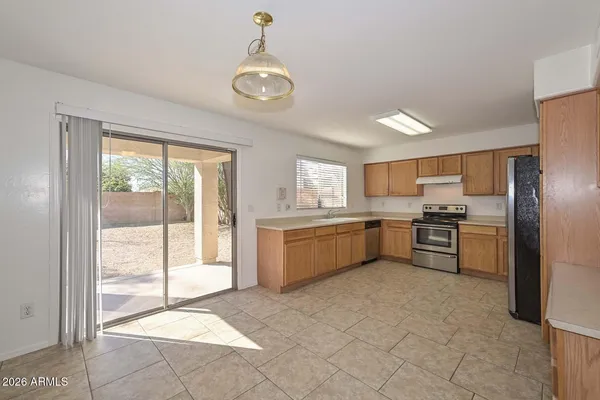 a large kitchen with a large window and stainless steel appliances