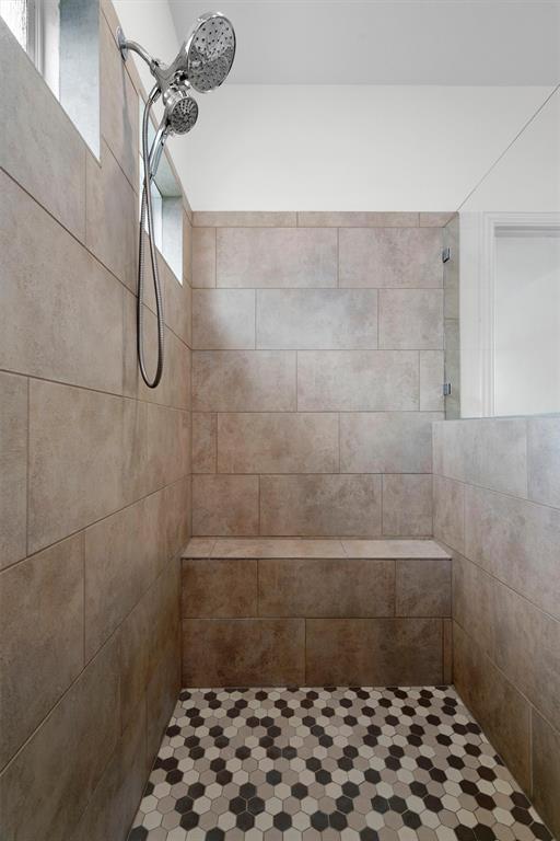 236 Prato Place Georgetown, TX 78628 - Photo 22 of 40 A well-appointed shower with built-in bench seating and decorative tile flooring.