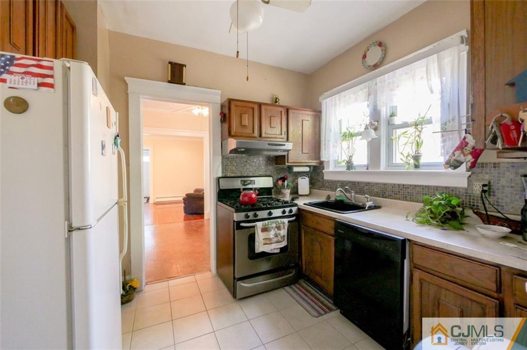 65 Meadow Road Edison, NJ 08817 - Photo 13 of 24 a kitchen with stainless steel appliances granite countertop a refrigerator and a stove