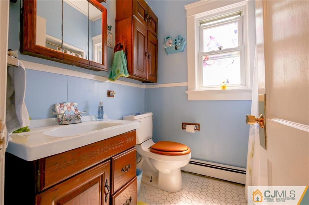 65 Meadow Road Edison, NJ 08817 - Photo 17 of 24 a bathroom with a sink toilet and a window