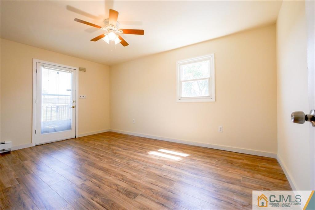 65 Meadow Road Edison, NJ 08817 - Photo 18 of 24 an empty room with wooden floor and windows